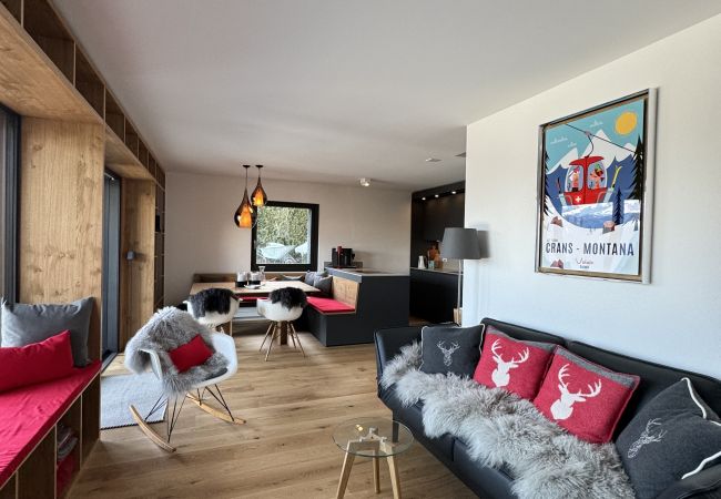 Cosy living room opening onto the dining room, with sofa and small rocking chair