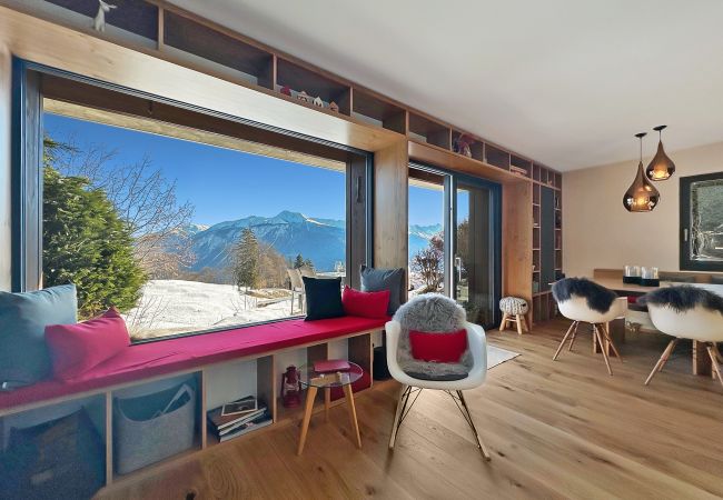 Bay window with dining area in the background and a small bench to take full advantage of the 180-degree view