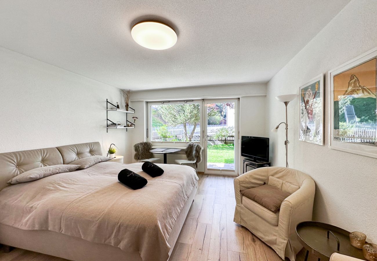 The comfortable interior of the studio with its large window and cosy double bed