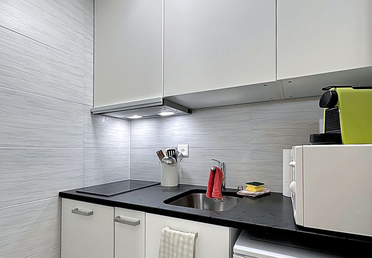 Fully equipped kitchen with coffee machine, microwave and practical storage space